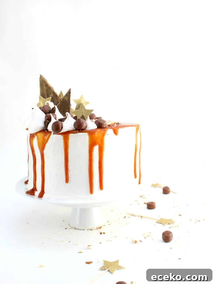 This cake is a sweet take on the classic Thanksgiving sweet potato casserole combining layers of moist sweet potato cake, decadent marshmallow frosting, and topped with caramel and chocolates! | The Simple, Sweet Life
