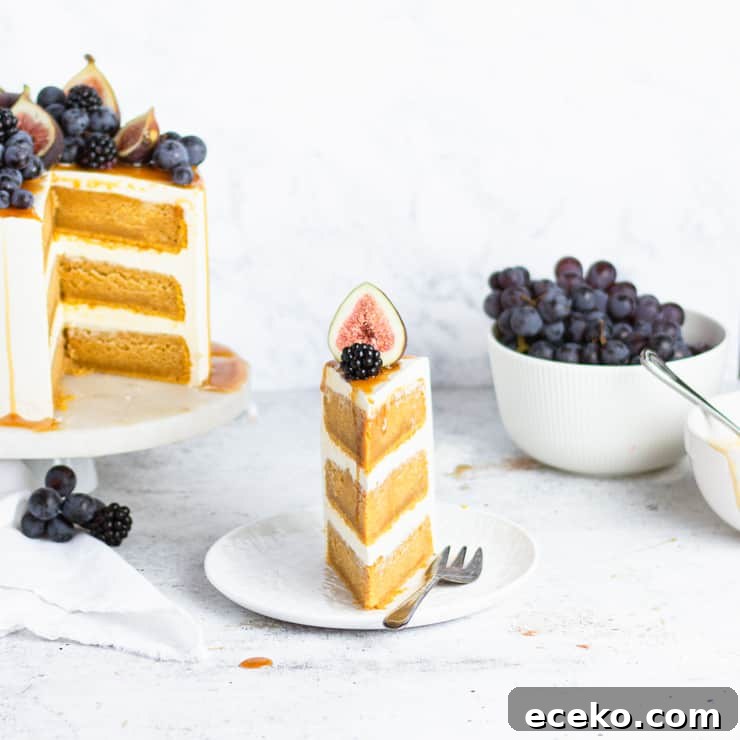 slice of cake next to cake and a bowl of grapes