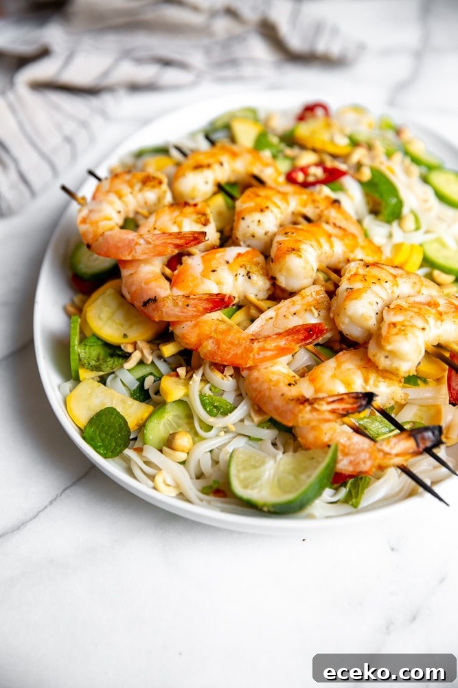 Vietnamese Cold Rice Noodle Salad with Garlicky Shrimp Skewers 2 Side angle shot of the Vietnamese rice noodle salad on a platter topped with grilled shrimp.