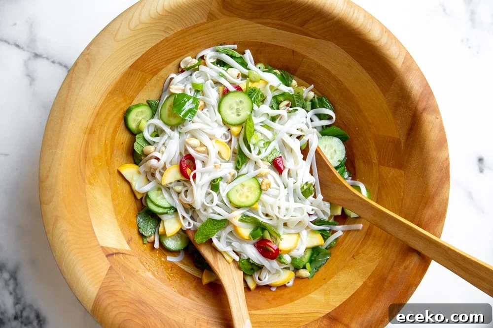 Vietnamese Cold Rice Noodle Salad with Garlicky Shrimp Skewers 5 Process shot showing the rice noodle salad in a large bowl after tossing.