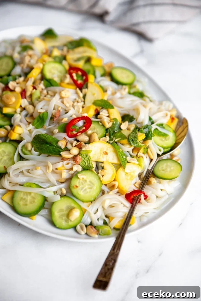Vietnamese Cold Rice Noodle Salad with Garlicky Shrimp Skewers 8 Cold rice noodle salad on a serving platter with a serving spoon.