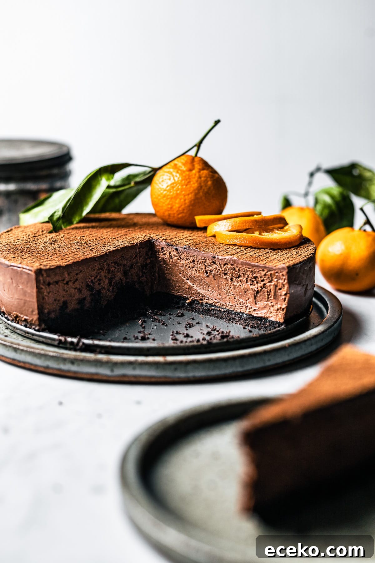 A sliced chocolate orange cheesecake showing the creamy interior and Oreo cookie crust.