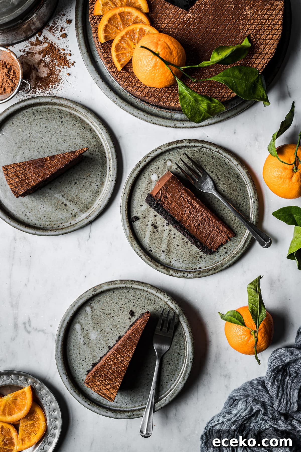 Slices of chocolate cheesecake with Oreo cookie crust on ceramic plates.