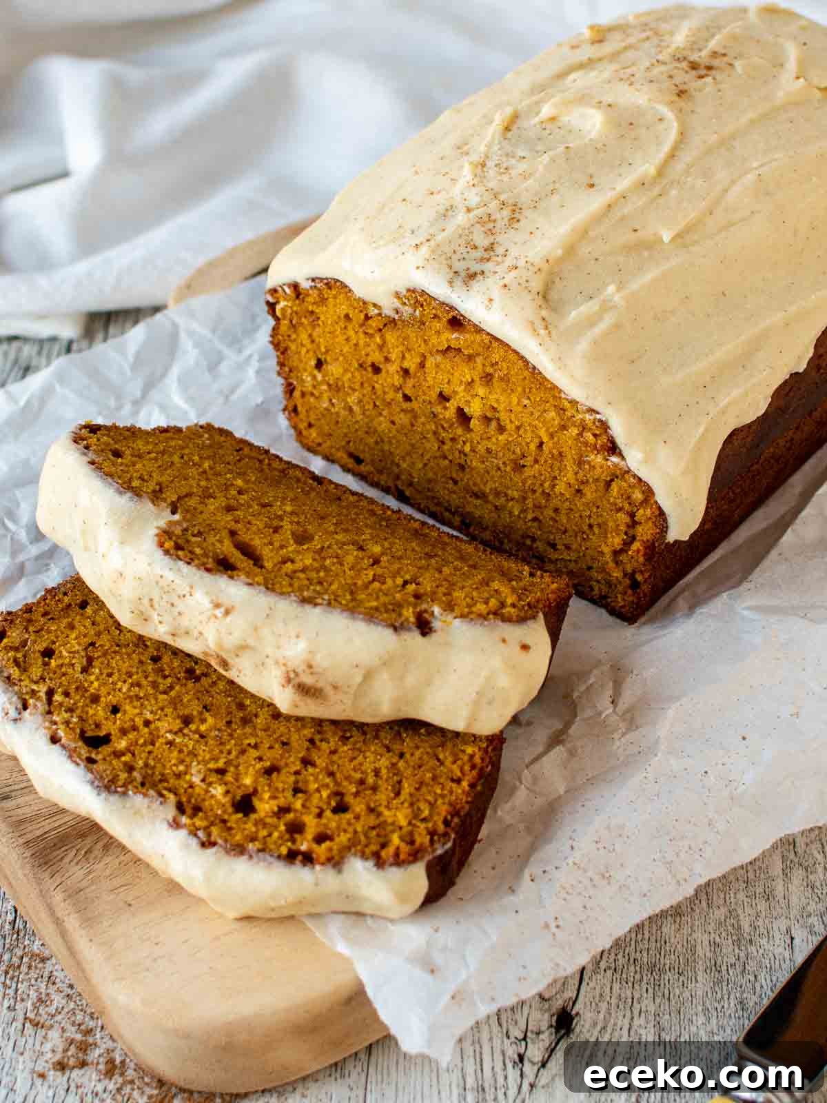 Pumpkin Bread with Cream Cheese Frosting with two slices cut.