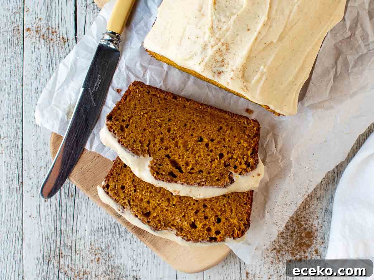 Overhead view of pumpkin loaf cake with two slices cut.