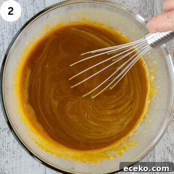 Whisking orange brown thick liquid.