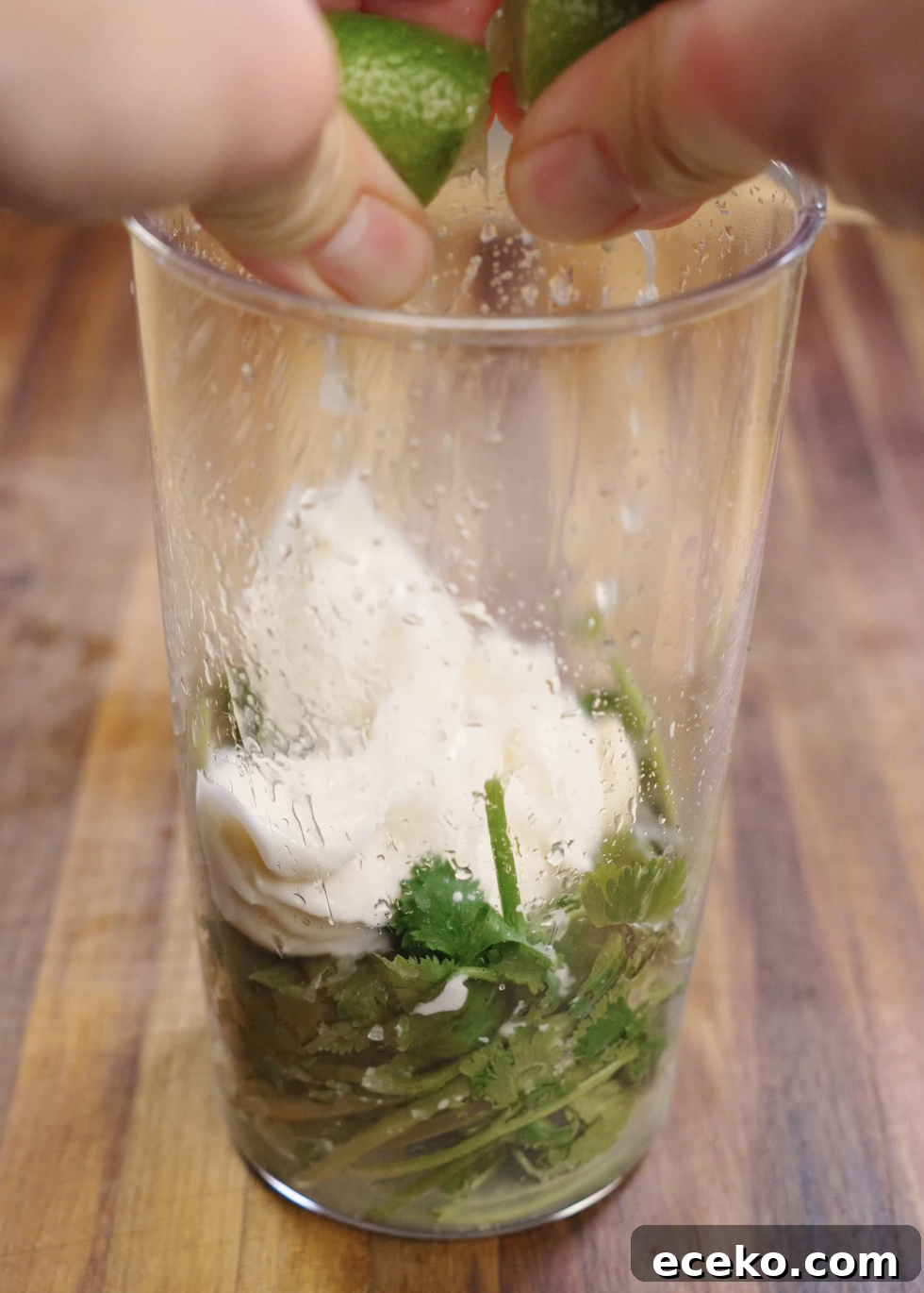 Crispy Chicken Tacos Recipe with Zesty Slaw and Lime крем 6 Fresh cilantro, mayonnaise, lime juice, salt, and water blended together in a tall container to create a smooth and creamy cilantro mayo sauce for crispy chicken tacos.