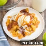 3-Ingredient Apple Dump Cake Recipe: Quick Crowd-Pleasing Dessert 11 Apple dump cake topped with vanilla ice cream and caramel sauce.