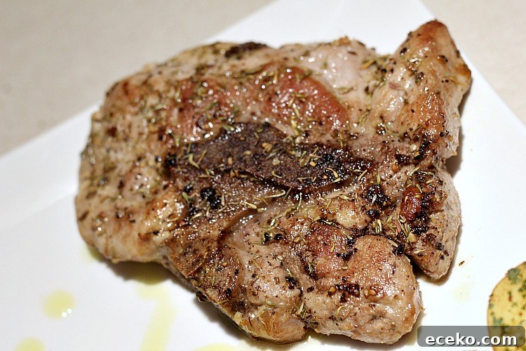 Garlic Butter Pork Chops in a Cast Iron Skillet Recipe 9 Garlic Butter Pork Chop on white plate served