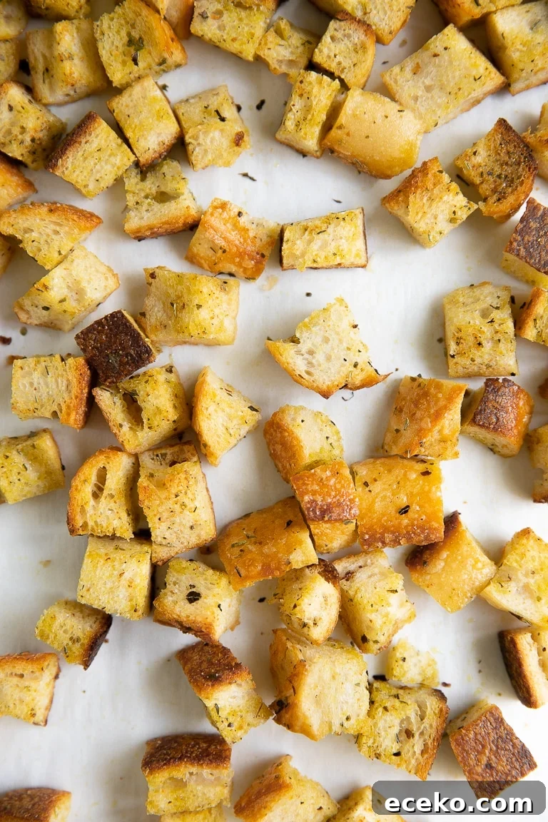 Crispy Homemade Croutons Recipe for Salads and Soups 3 Baking sheet filled with homemade toasted croutons.