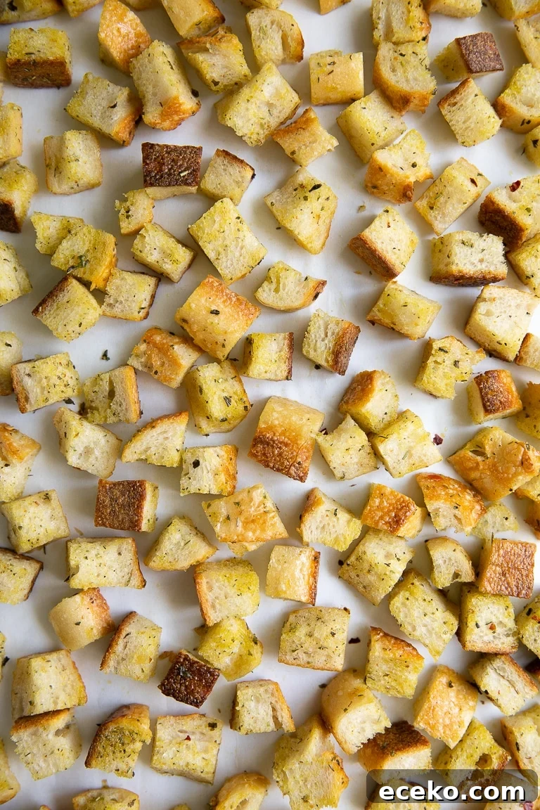 Crispy Homemade Croutons Recipe for Salads and Soups 4 Chopped cubes of bread tossed in olive oil, salt, pepper, and Italian seasoning, spread over a large baking sheet.