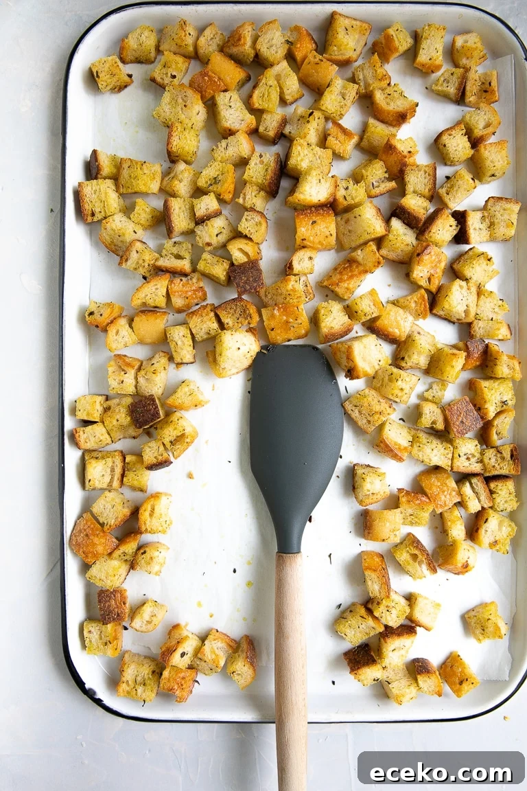Crispy Homemade Croutons Recipe for Salads and Soups 5 Large white baking sheet filled with homemade toasted croutons.