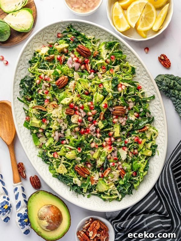 Crispy Homemade Croutons Recipe for Salads and Soups 8 Finished Brussels sprout salad on an oval platter with lemon wedges and avocado