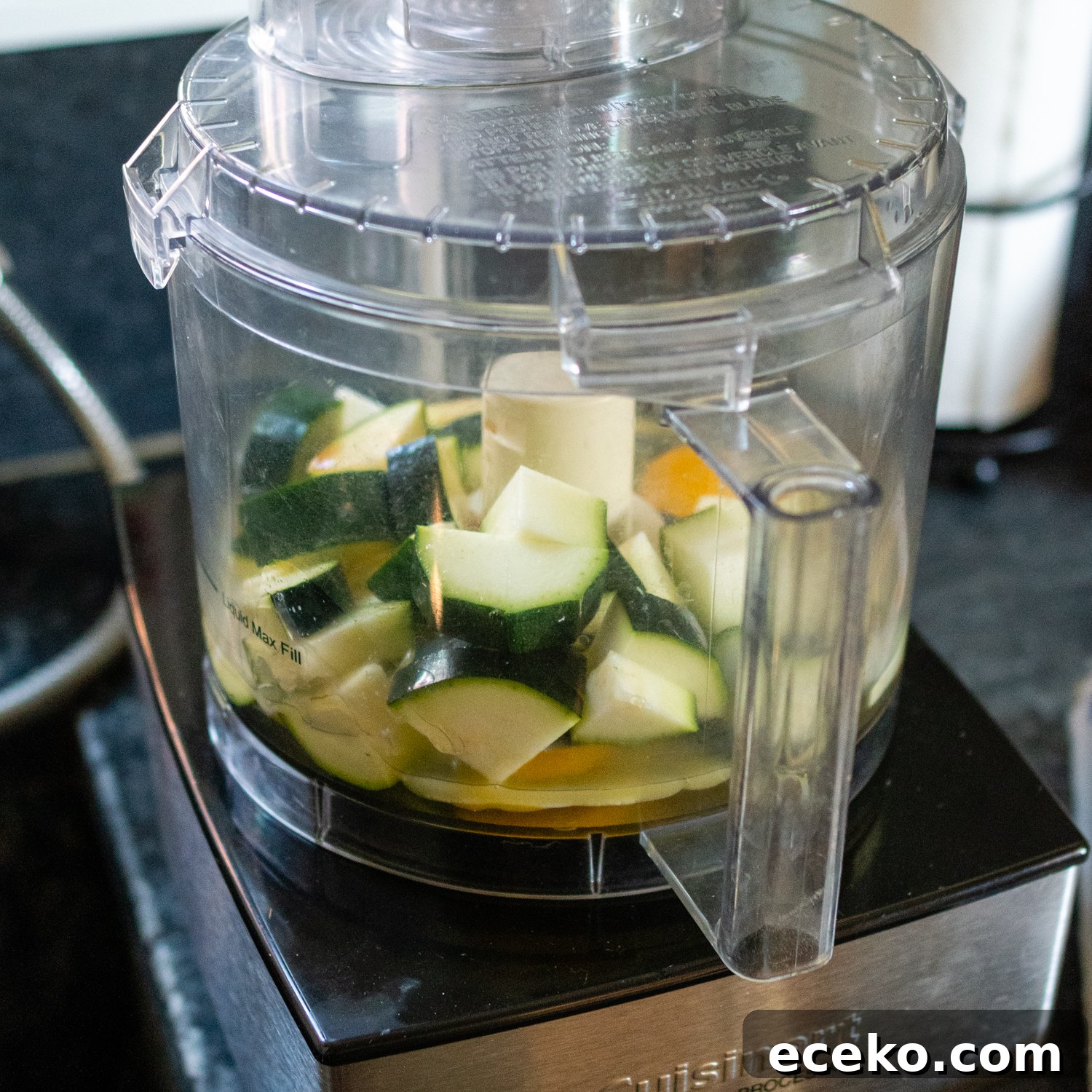 large chunks of zucchini in a food processor.