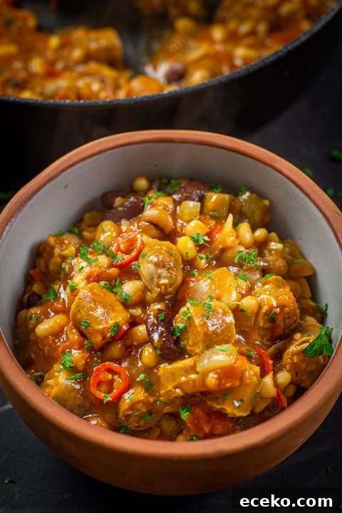 Cowboy Stew Recipes: Campfire, Stovetop, Oven & Slow Cooker Methods 15 Bowl of cowboy stew with a pan of the stew in the background
