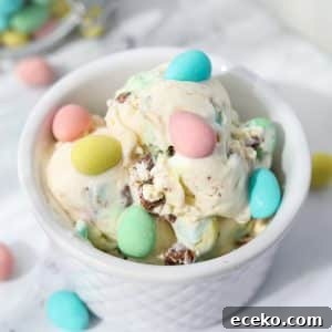 A white bowl filled with ice cream and dotted with Cadbury Mini Eggs.