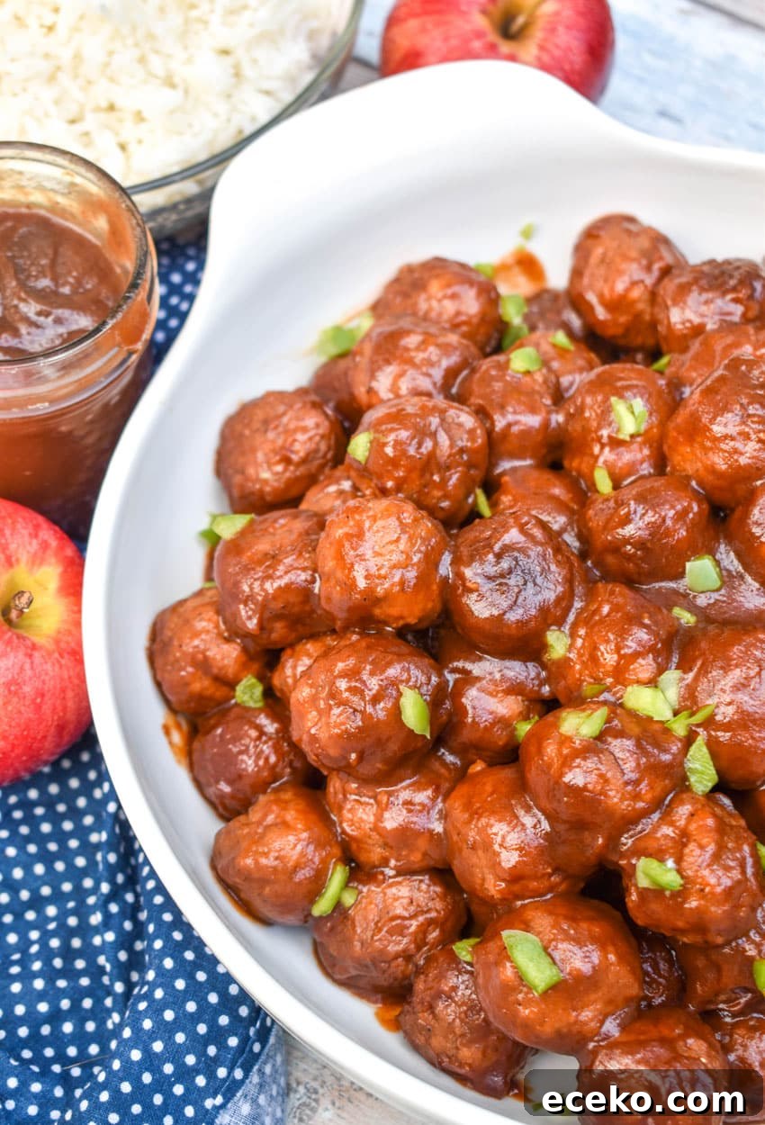 Slow Cooker Apple Butter Meatballs: Sweet Savory Dinner Recipe 2 apple butter meatballs sprinkled with diced green peppers in a white serving bowl