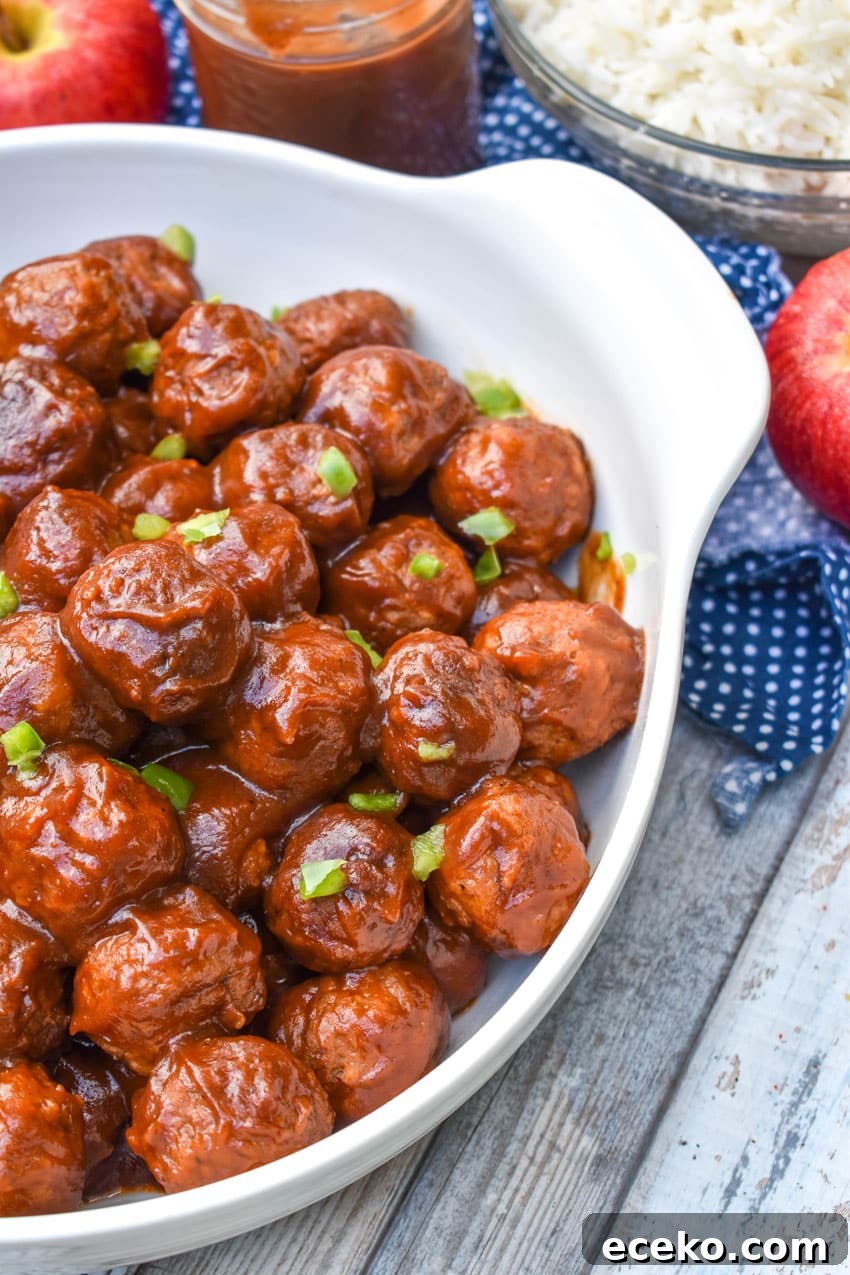 Slow Cooker Apple Butter Meatballs: Sweet Savory Dinner Recipe 3 apple butter meatballs sprinkled with diced green peppers in a white serving bowl
