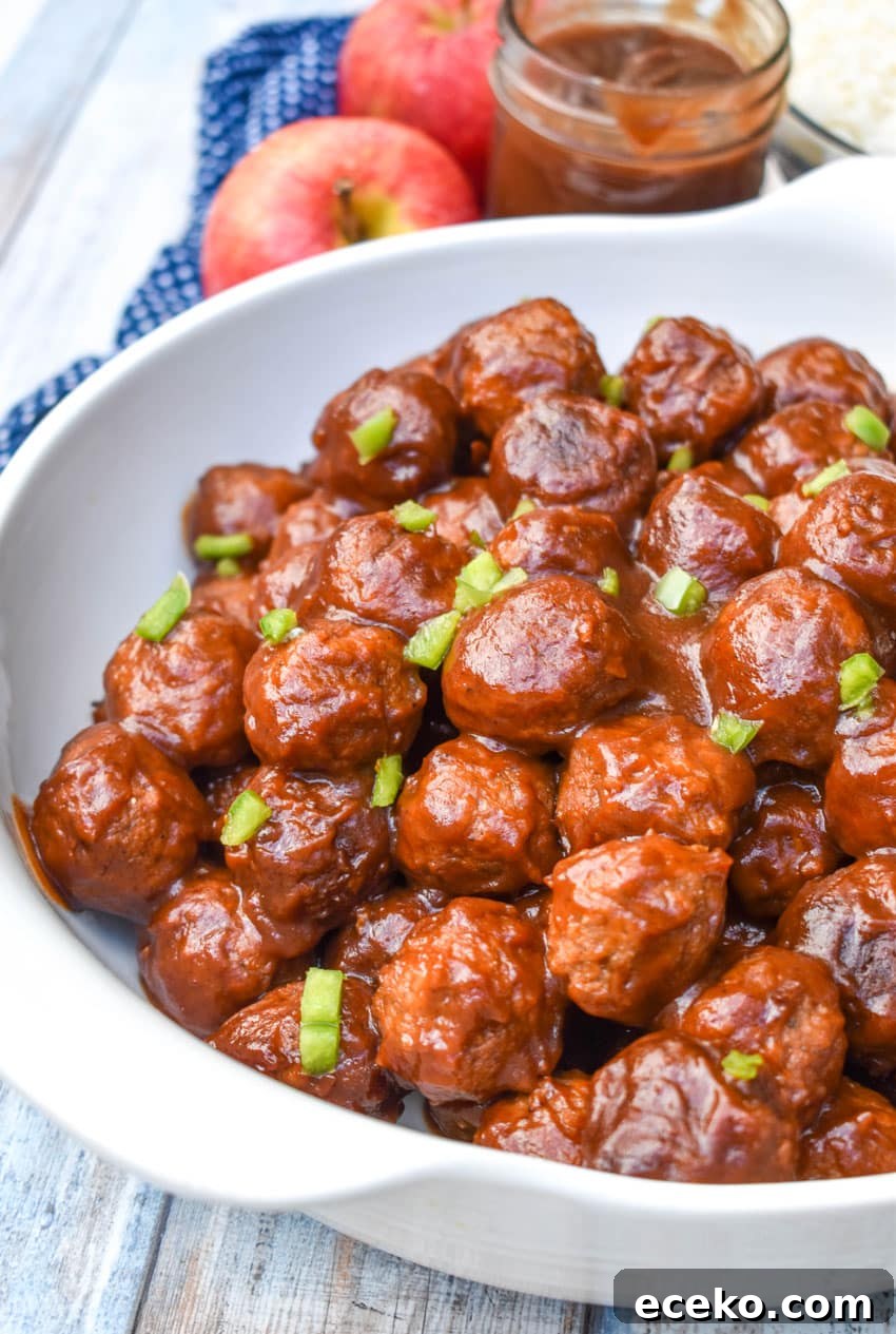 Slow Cooker Apple Butter Meatballs: Sweet Savory Dinner Recipe 6 apple butter meatballs sprinkled with diced green peppers in a white serving bowl