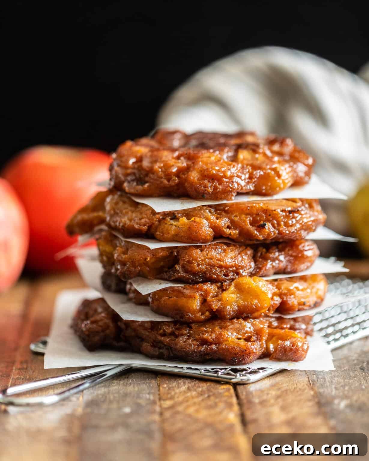 apple pear fritters stacked on top of each other with apples in the background