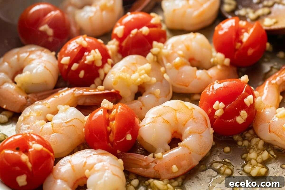 Garlic added to the shrimp and tomatoes.