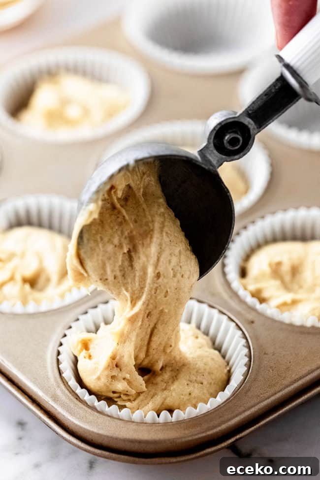 scooping batter into a cupcake liner