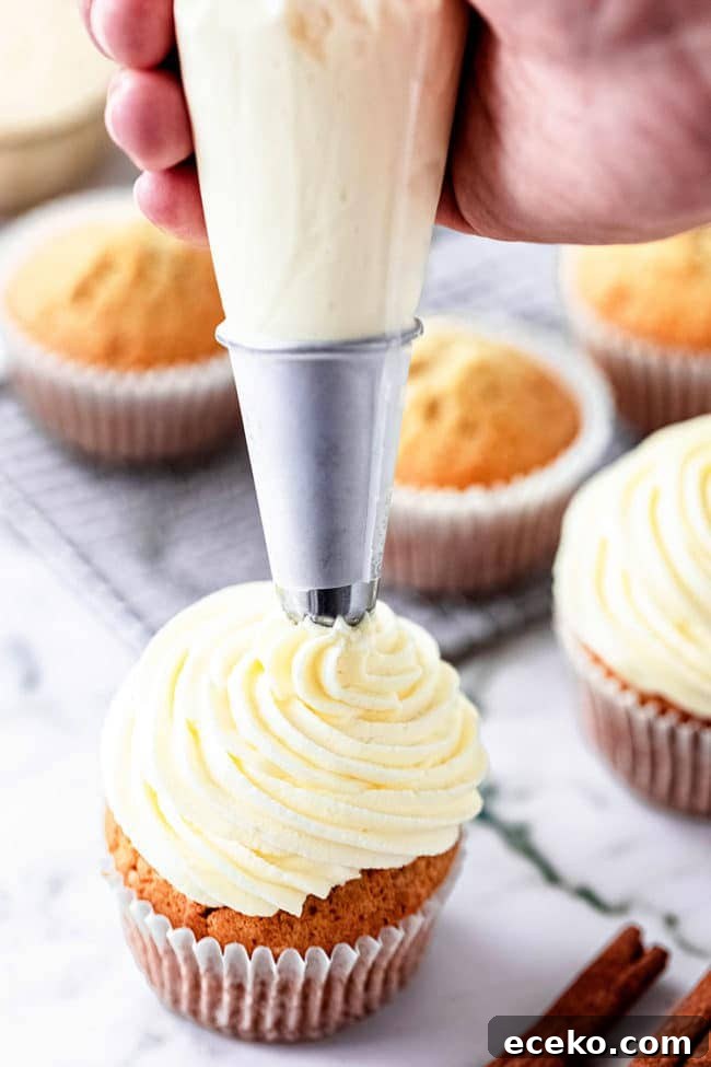 piping buttercream on a cupcake