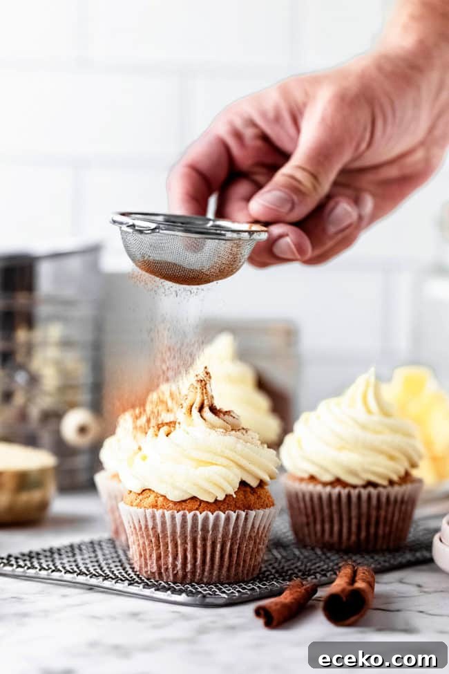 dusting cupcakes with cinnamon