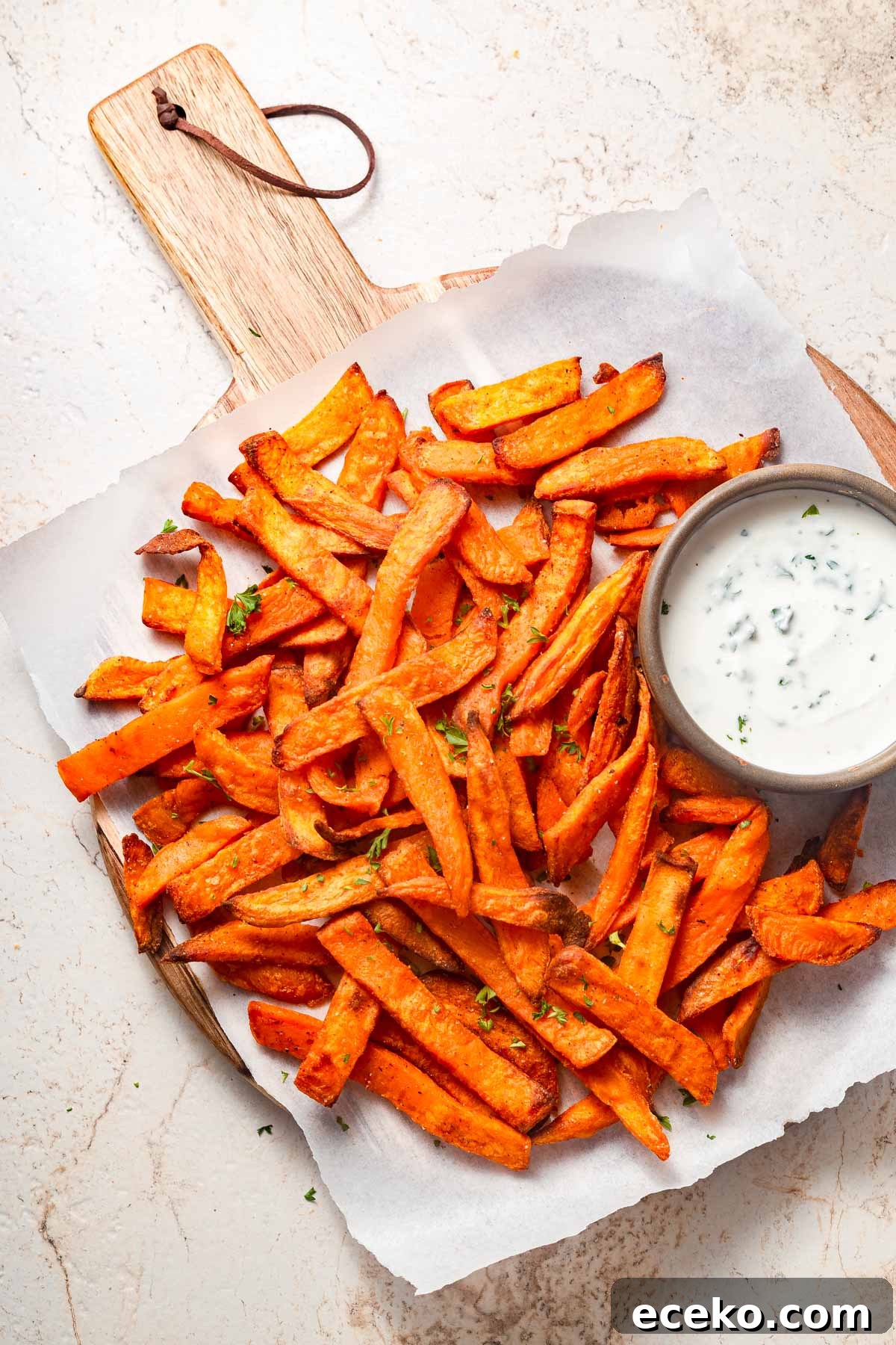 Crispy Frozen Sweet Potato Fries in the Air Fryer 2 frozen sweet potato is air fried and presented with a dip.