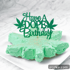 A white countertop and a white plate with a green frosted cannabis cake