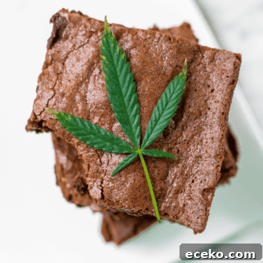 A picture of a stack of cannabis brownies with a cannabis leaf.