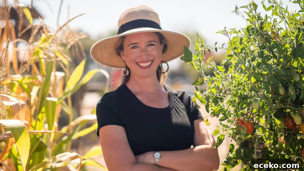 How to Practice Regenerative Gardening at Home 2 Lisa Bronner standing between corn and tomatoes in her garden. how to garden using regenerative practices. Regenerative Gardening