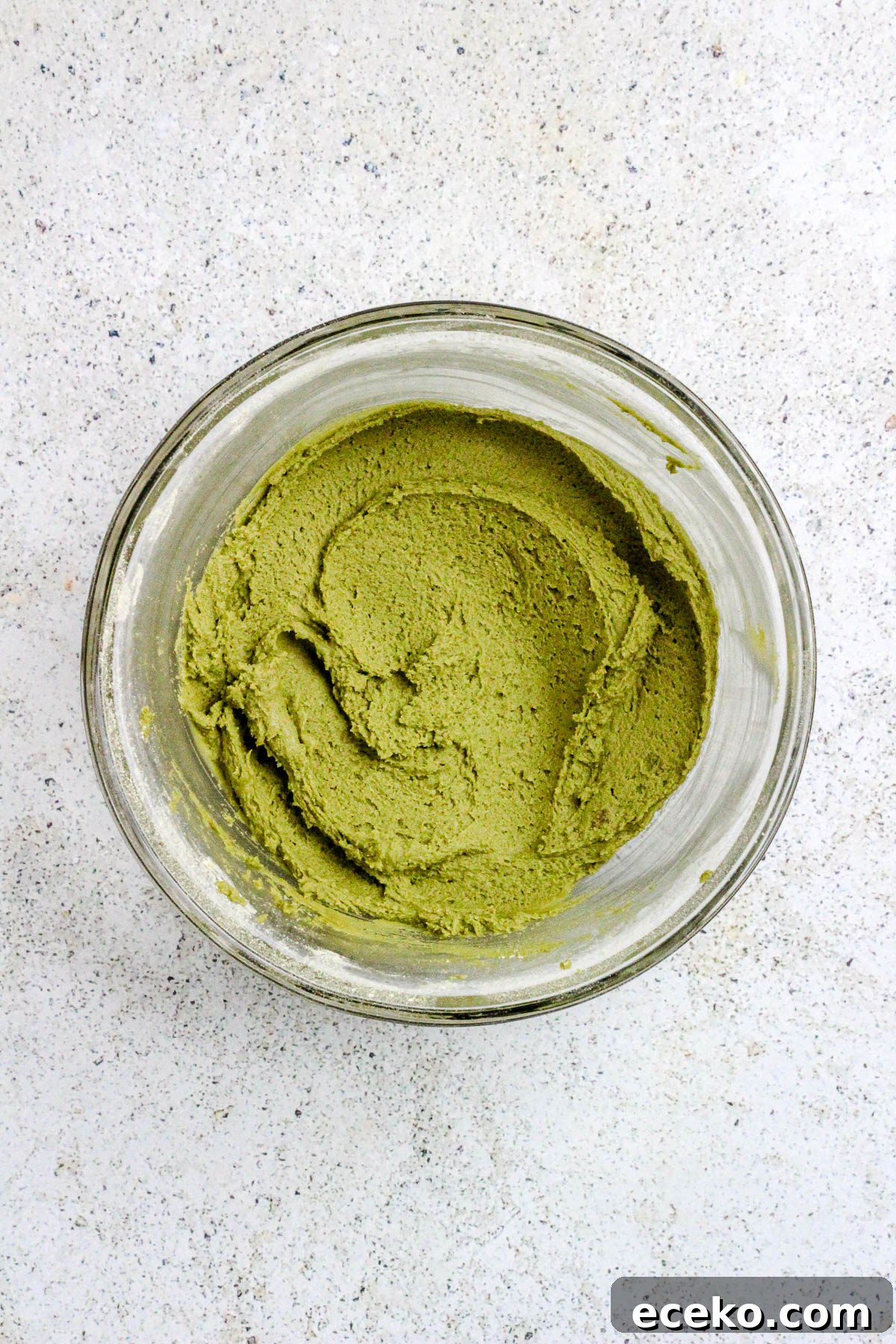 Matcha cookie dough in a glass bowl.