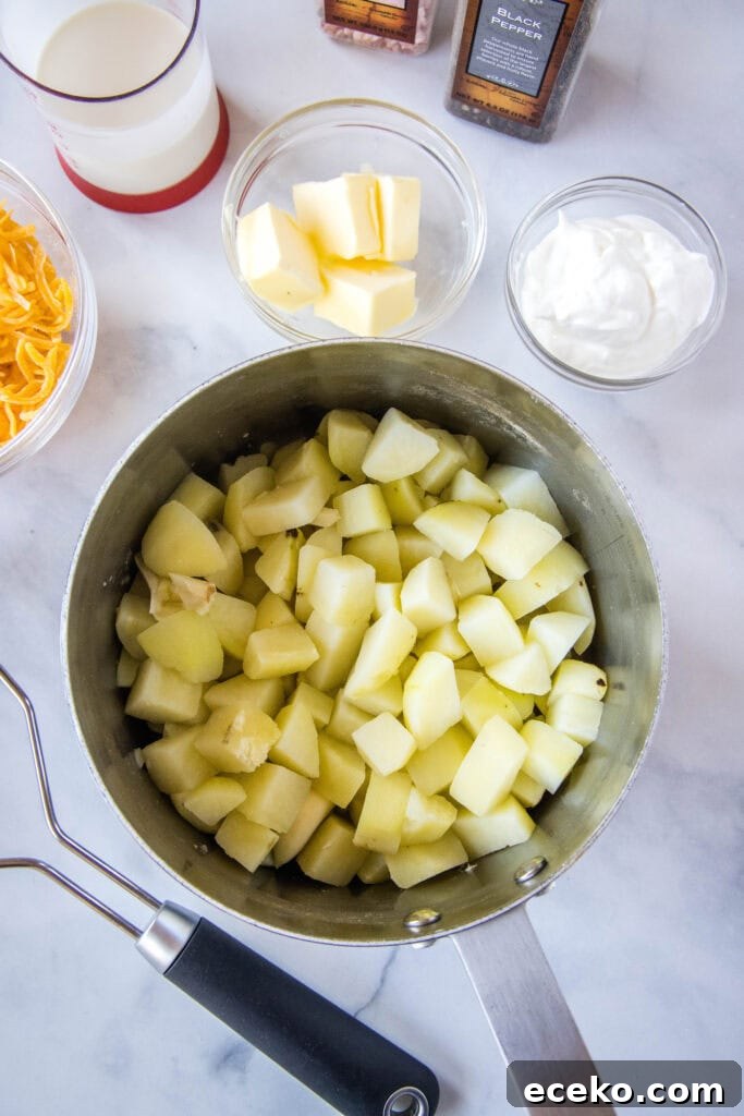 cooked potatoes in a pot ready to add butter and sour cream to
