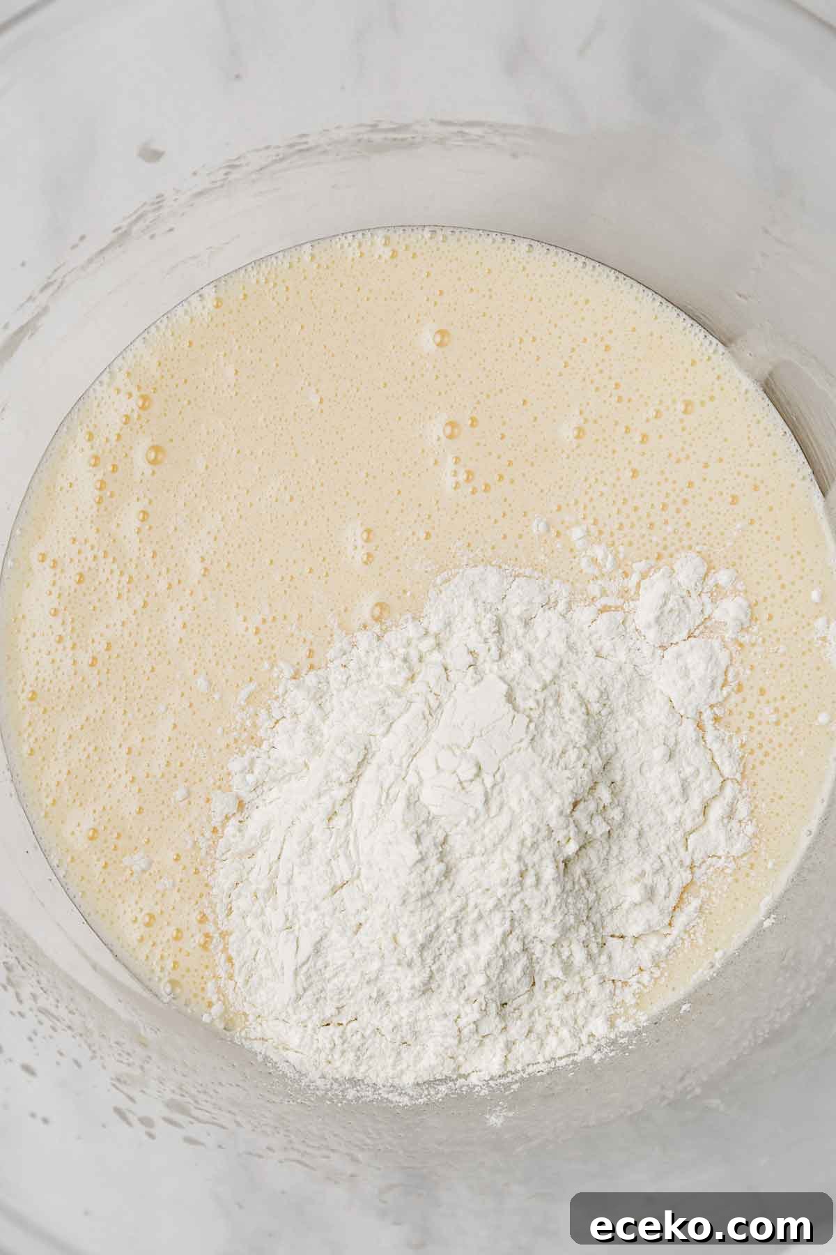 mixing bowl with vanilla cupcake batter made with oil