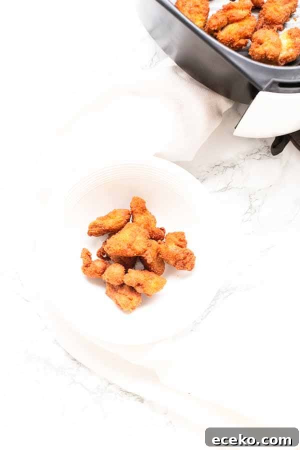 Make the best Air Fryer chicken nuggets with chicken thighs, seasoning and a little bit of oil to turn it into crispy nuggets. You can serve them as a snack, or with dinner.