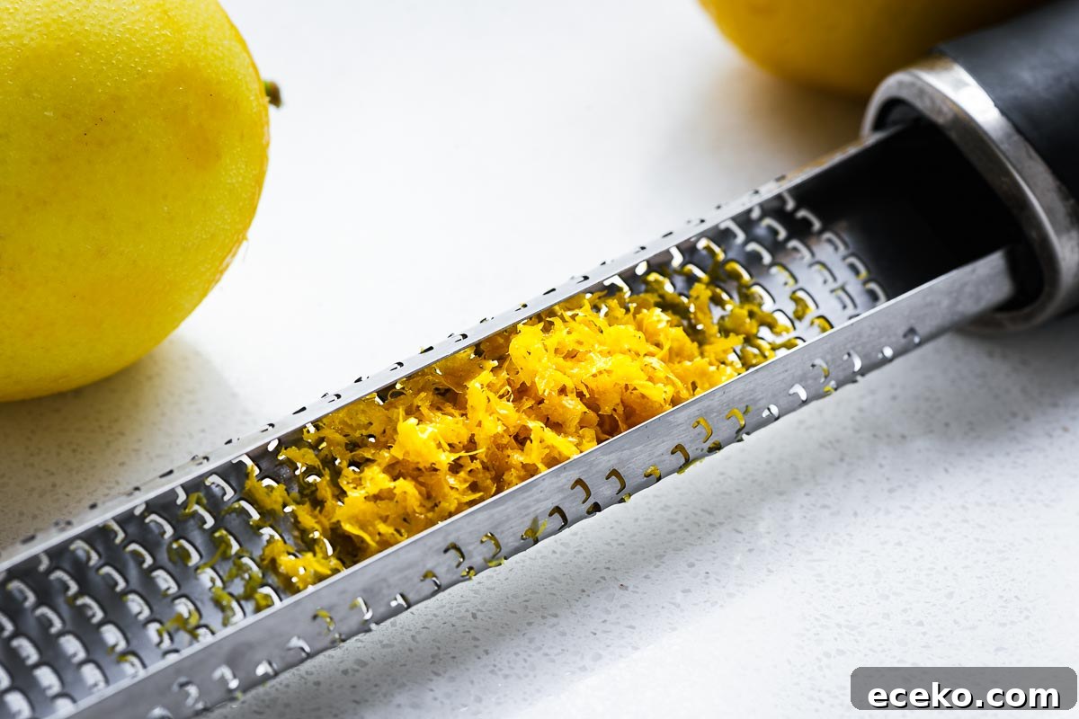 A close-up of a Microplane zester with lemon zest.