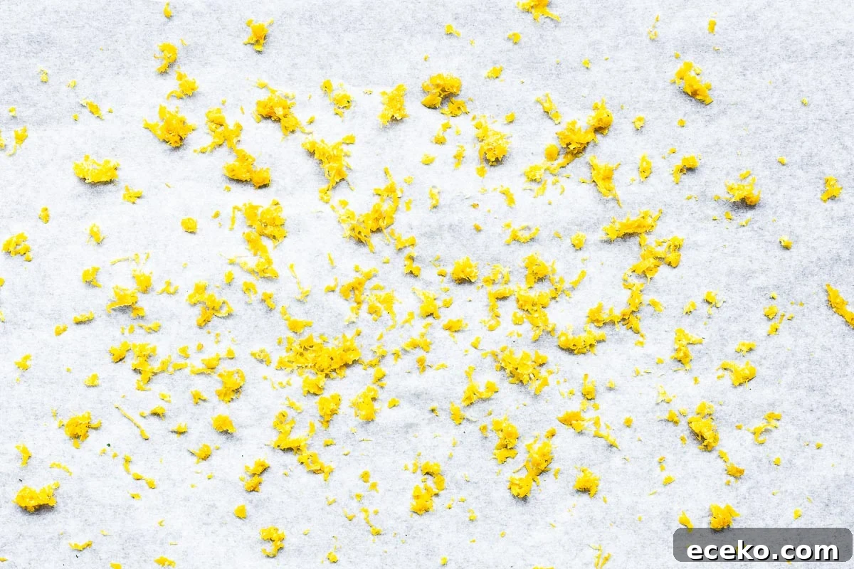 Lemon zest on parchment paper viewed from above.