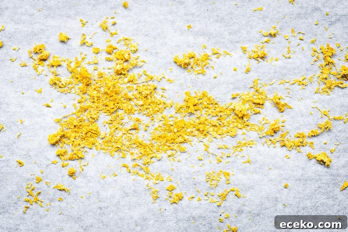 Oven-dried lemon zest on baking paper viewed from above.