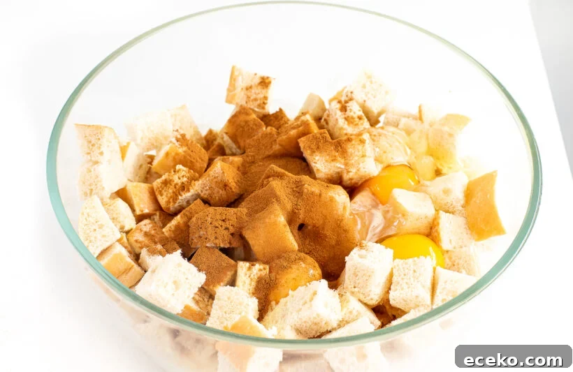 Eggnog casserole ingredients in a glass mixing bowl.