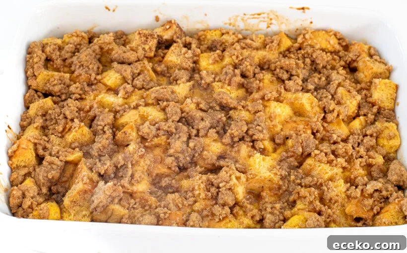 Golden and baked eggnog casserole in a white baking dish.