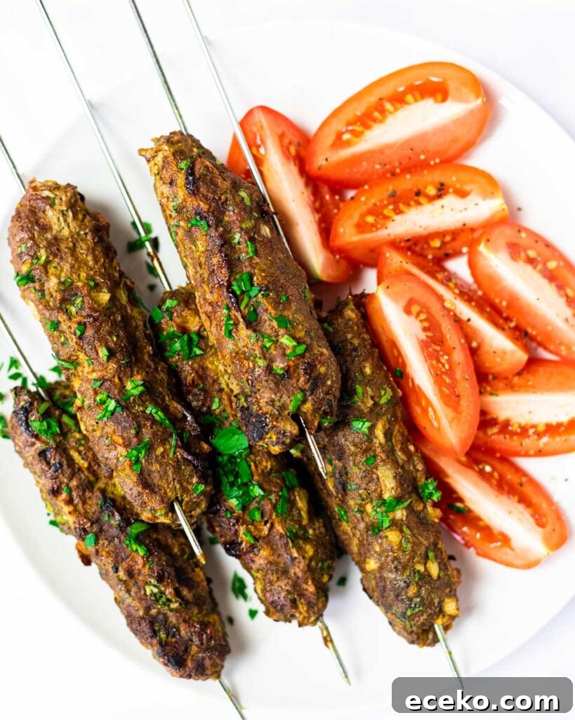A top down view of a plate of beef kofta kebabs.