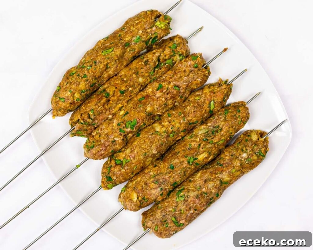 raw beef kofta kebabs on a plate
