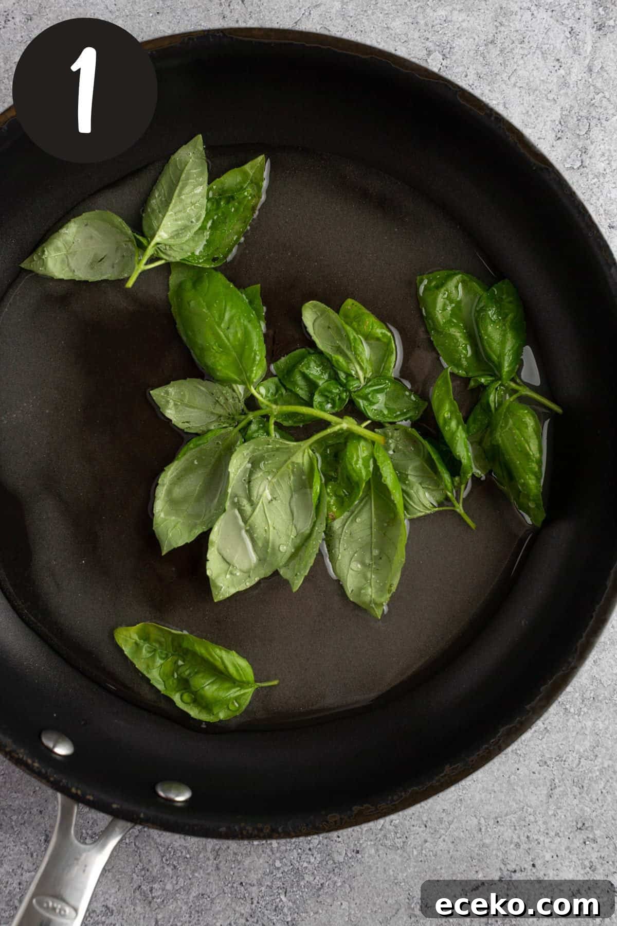 Heating the basil leaves, sugar and water together in a saucepan.