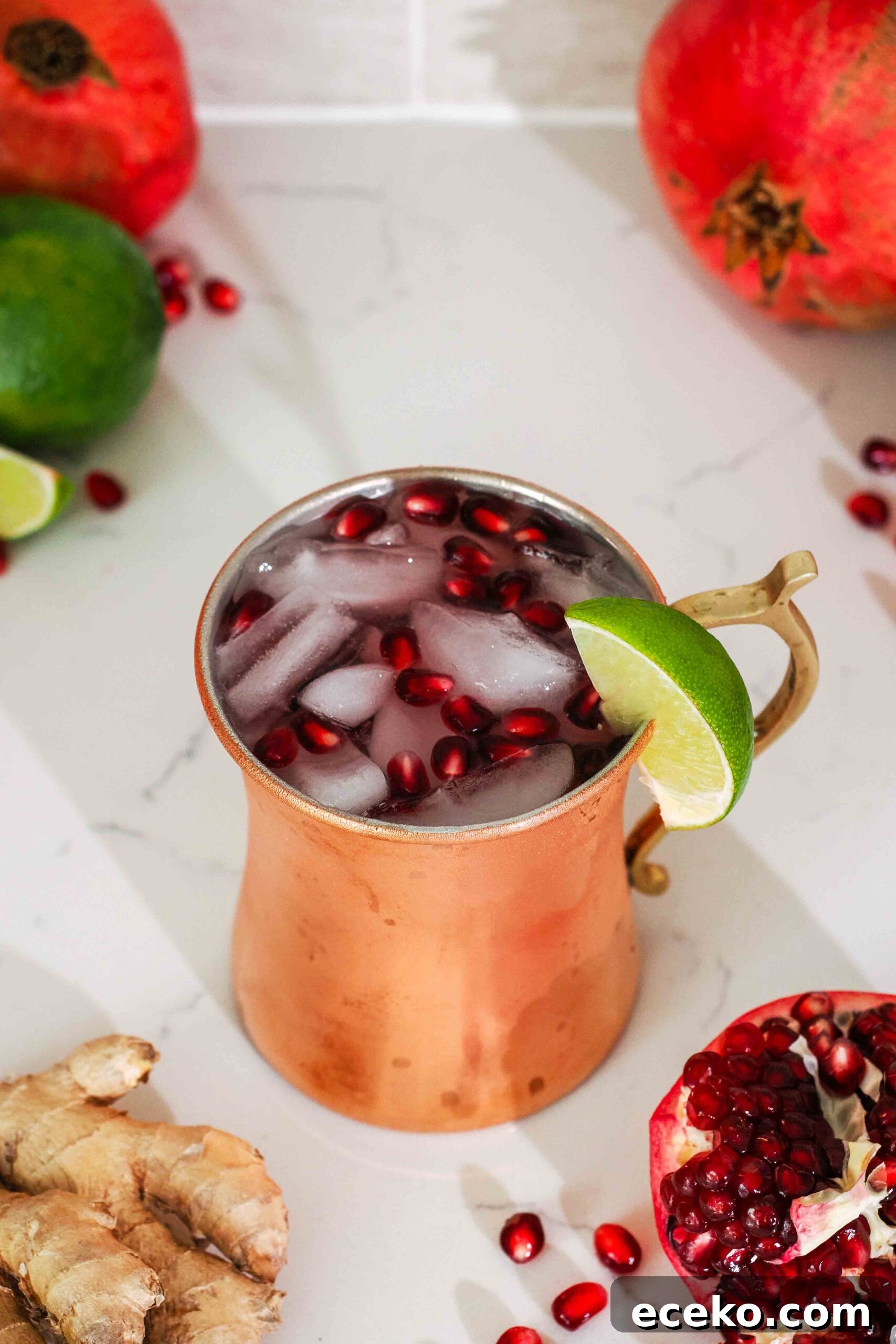 An overhead angled image of a pomegranate mule in a copper mug.