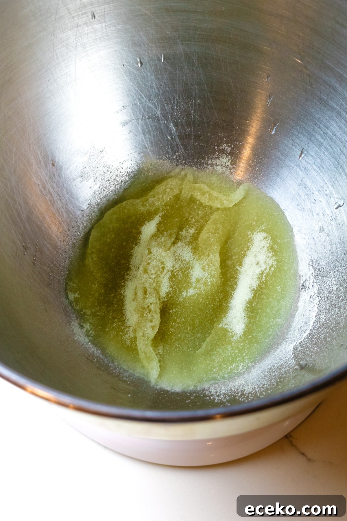 Homemade Marshmallows Without Corn Syrup — Simple Recipe 4 gelatin being bloomed with a bit of water in a bowl of a stand mixer.