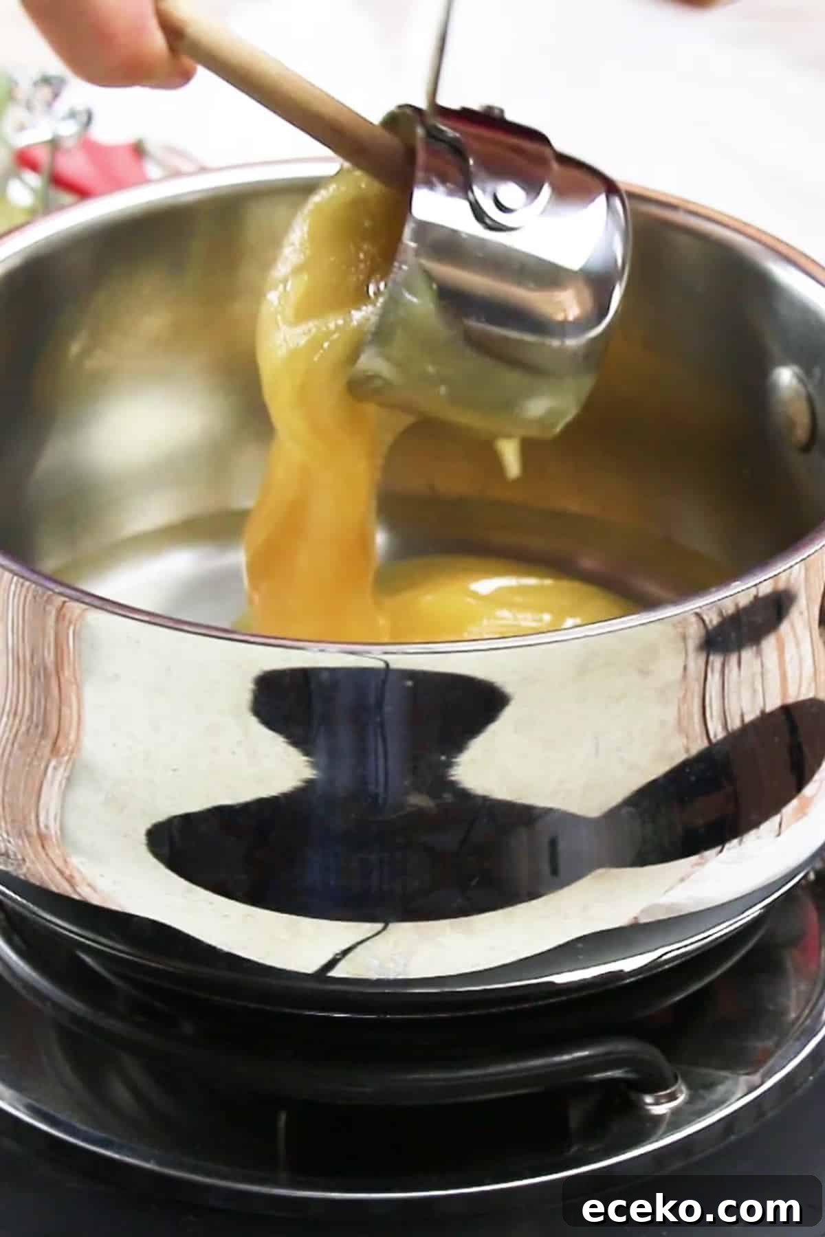 Homemade Marshmallows Without Corn Syrup — Simple Recipe 5 honey added to a stockpot of water over medium high heat to make marshmallows.