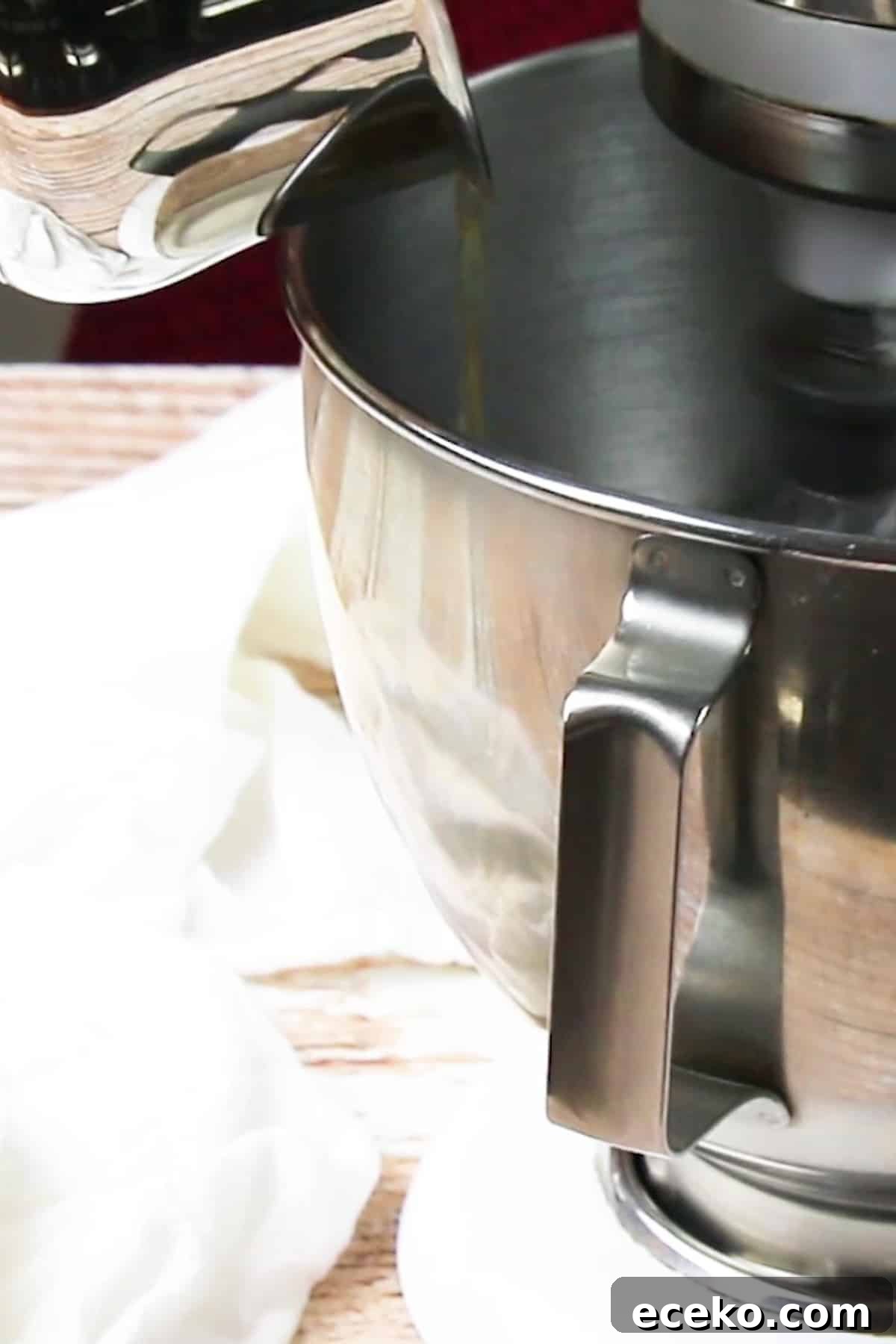 Homemade Marshmallows Without Corn Syrup — Simple Recipe 6 honey simple syrup poured into a bowl of stand mixer to make homemade marshmallows.