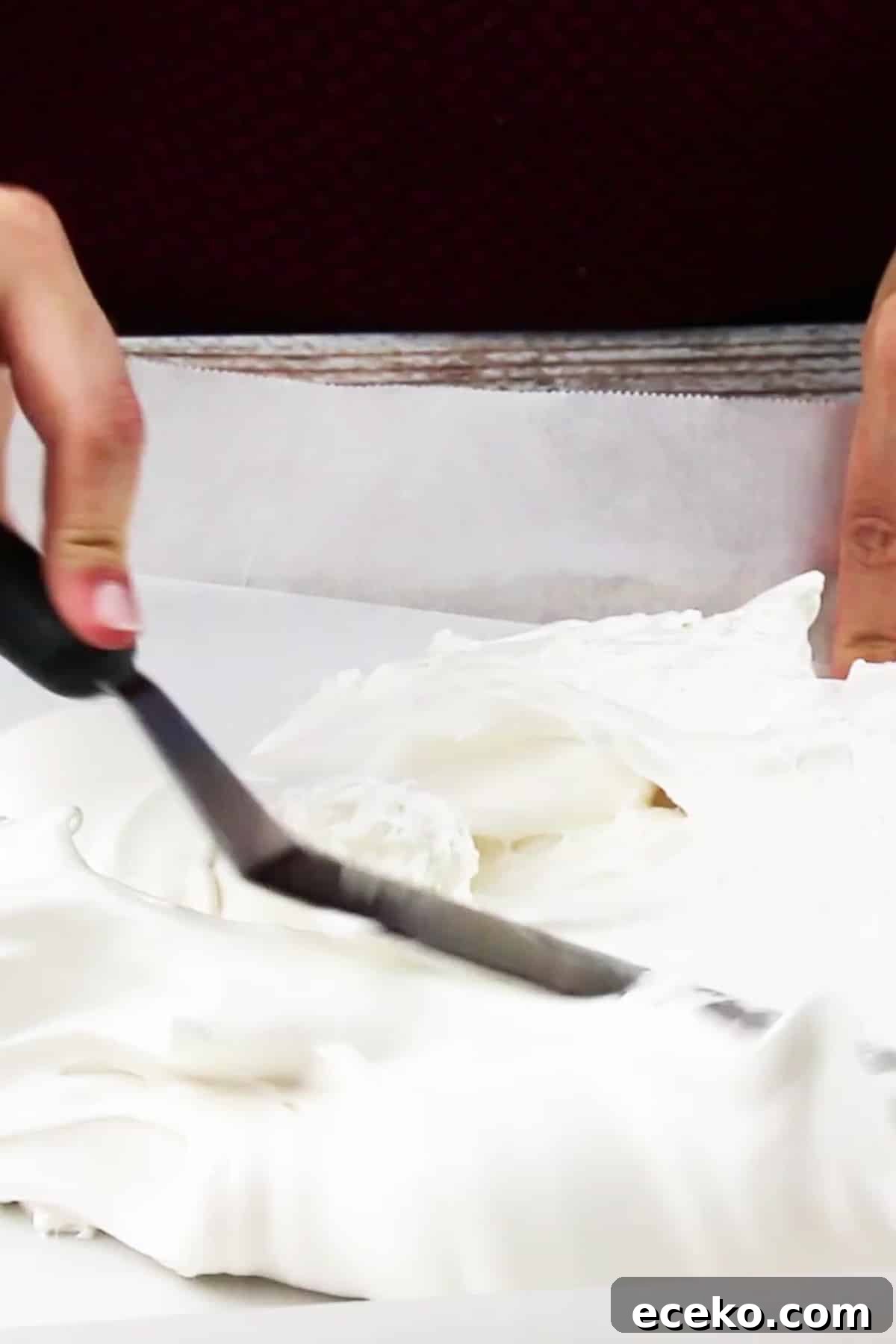 Homemade Marshmallows Without Corn Syrup — Simple Recipe 8 marshmallow fluff being spread out on a sheet pan lined with parchment paper.