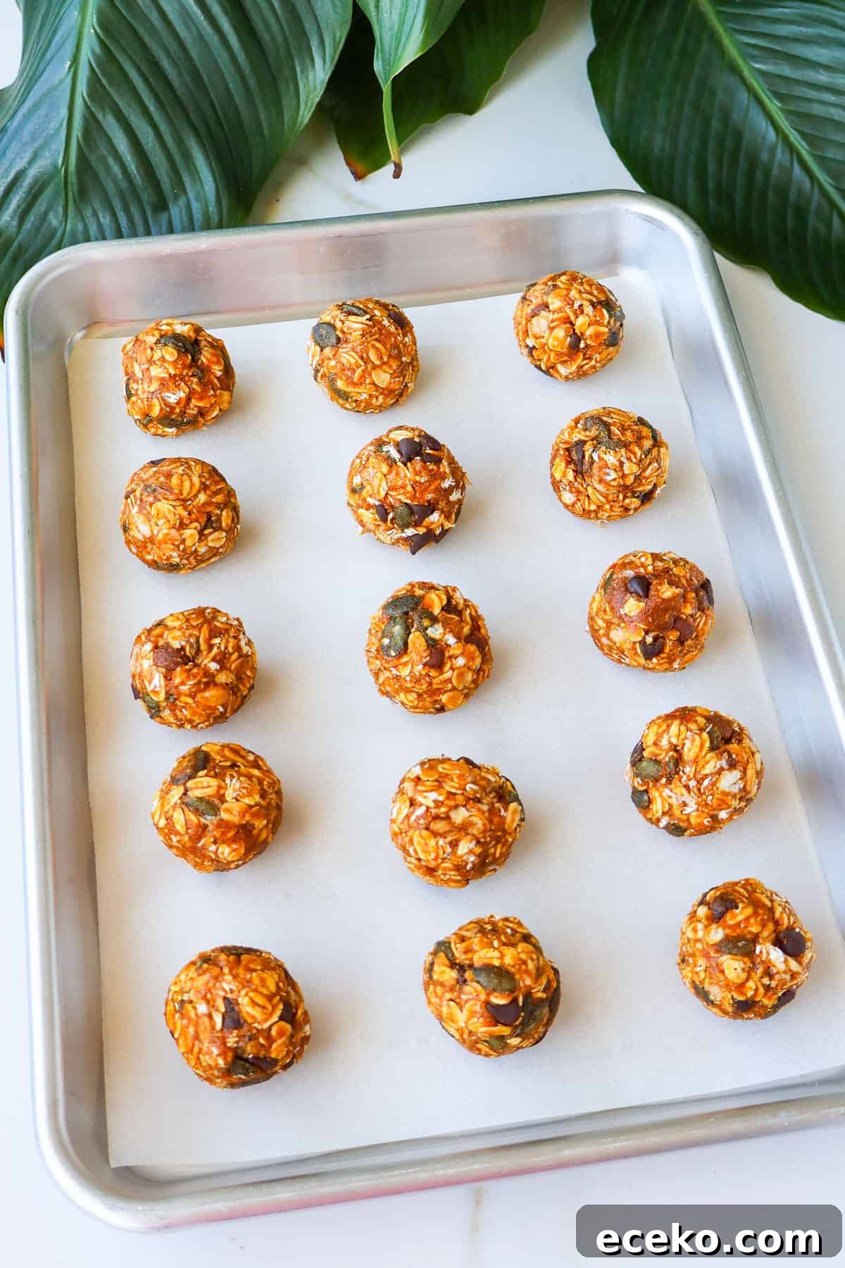 Pumpkin protein balls on a baking sheet.